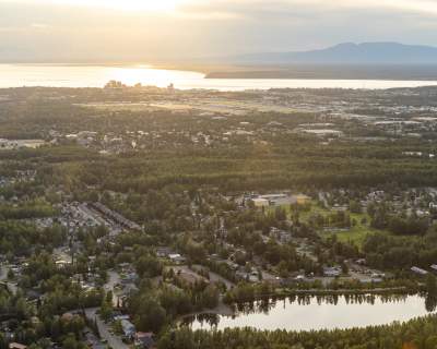 An aerial of Anchorage facing west, with Cook Inlet and Mount Susitna beyond.