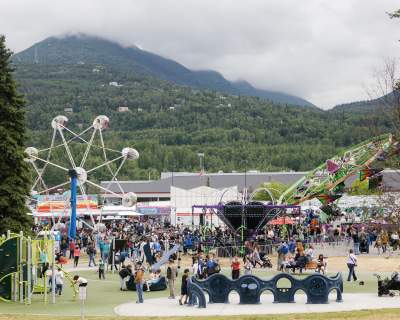 Locals and visitors browse vendor booths, and ride carnival rides at the Bear Paw Festival in Eagle River, Alaska