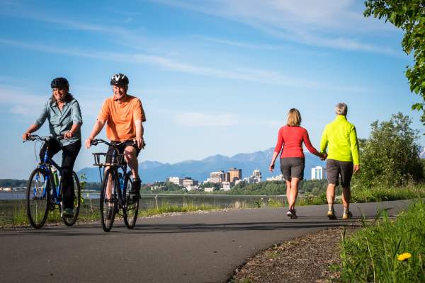 A couple biking on Anchorage's Tony Knowles Coastal Trail