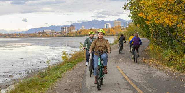 Bikers on the Tony Knowles Coastal Trail in fall