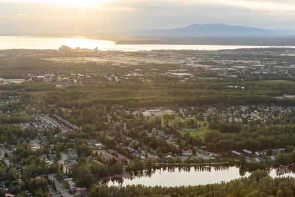 An aerial of Anchorage facing west, with Cook Inlet and Mount Susitna beyond.