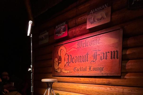 A stage with a microphone and seat for Comedy by the Creek at the Peanut Farm.