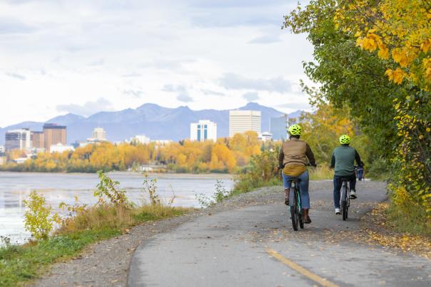 Two people riding bikes on a fall day in Anchorage along the Cook Inlet Coast.