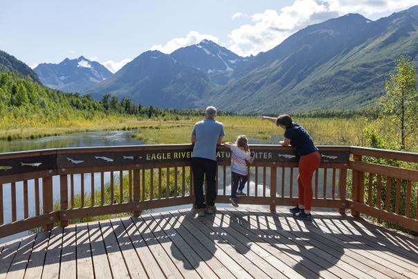 Family on the boardwalk at Eagle River Nature Center.