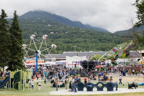 Locals and visitors browse vendor booths, and ride carnival rides at the Bear Paw Festival in Eagle River, Alaska