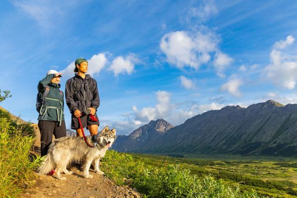 Two people and a dog hike the trails in the Glen Alps area of Chugach State Park  in Anchorage, Alaska.