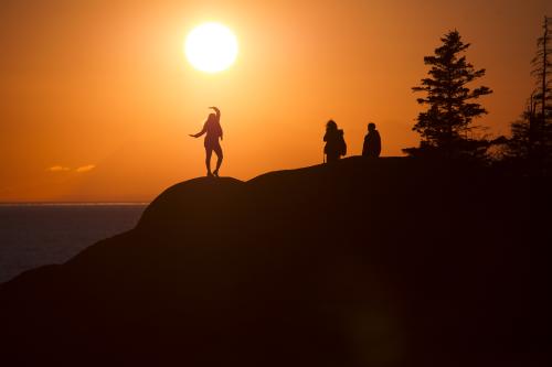 People silhouetted by the summer sun at Beluga Point.