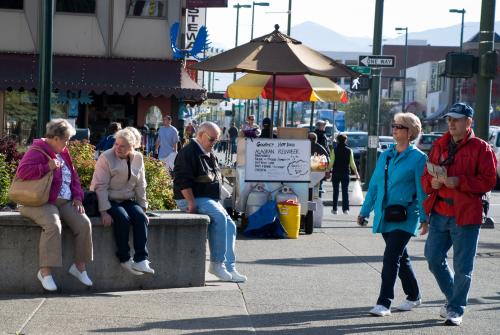 Visitors walk along Fourth Avenue in downtown Anchorage during summer.
