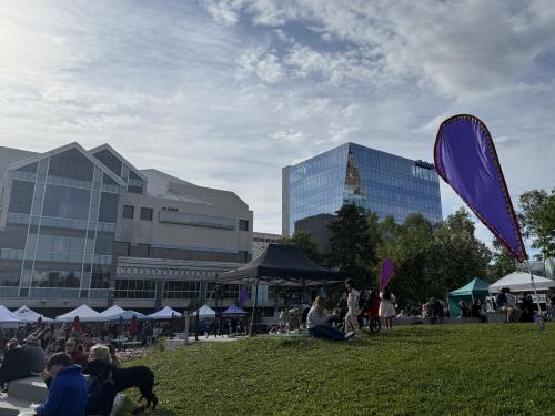 The Anchorage Summer Night Market at Town Square in downtown Anchorage with the Performing Arts Center in the background.