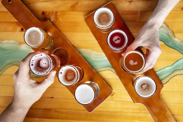 A cider flight from Double Shovel Cider Company lined up on wooden tasting paddles.