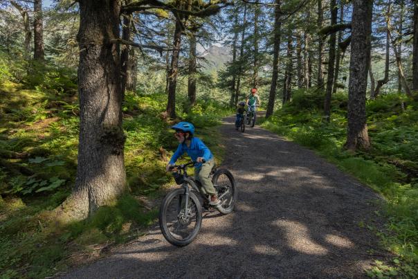A family bikes along the Trail of Blue Ice.