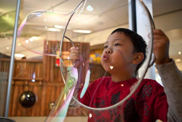A child blows a bubble in the Discovery Center at the Anchorage Museum.