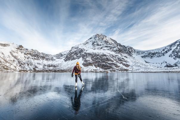 A person skates on wild ice on Rabbit Lake in Chugach State Park.
