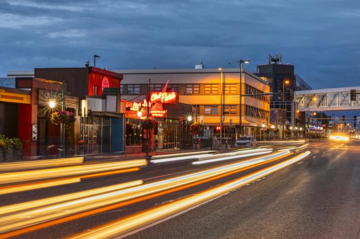 Car lights streaking by Club Paris in Downtown Anchorage.