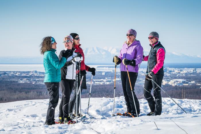 Group of cross-country skiers near Flattop Mountain with Anchorage and Mount Susitna in the background.