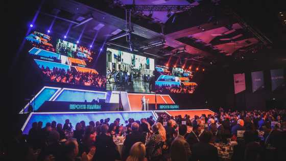 Esports Stadium Arlington meeting - wide angle of stage with speaker and audience