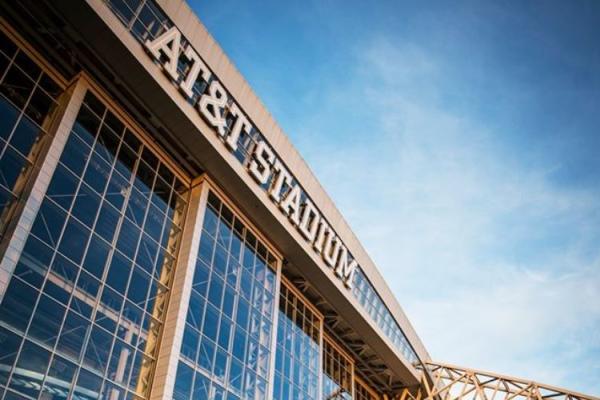 Photo of front of AT&T Stadium with sky reflection