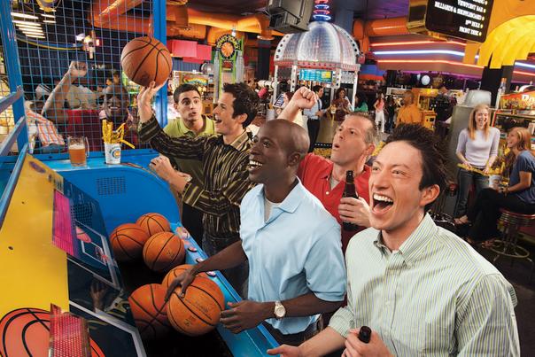 Guys playing pop a shot basketball