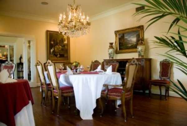 Elegant dining area of Restaurant506 at The Sanford House in Arlington, featuring classic décor, white tablecloths, and ambient lighting