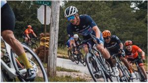 Men cyclist lean into a left curve on a street course.