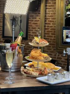 Three tiered tray of various seafood with a glass of champagne.