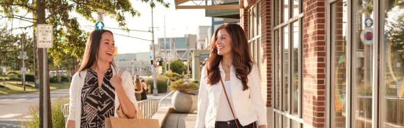 Two women walking with shopping bags