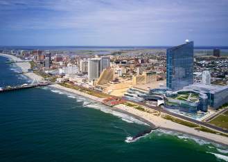 Skyline of Atlantic City, NJ with beach, resorts, Boardwalk, and the Steel Pier in view.