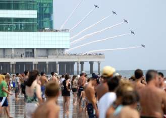 Planes fly in formation as onlookers watch performers in the Atlantic City Airshow in 2019.