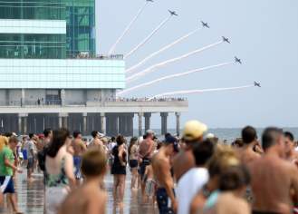 Planes fly in formation as onlookers watch performers in the Atlantic City Airshow in 2019.