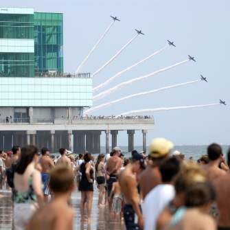 Planes fly in formation as onlookers watch performers in the Atlantic City Airshow in 2019.