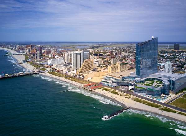 Skyline of Atlantic City, NJ with beach, resorts, Boardwalk, and the Steel Pier in view.