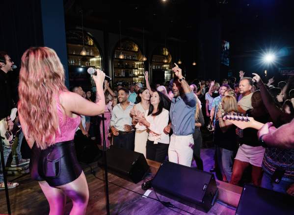Band members perform on stage as people gather and dance to live music at Nola's Bar in Ocean Casino Resort.