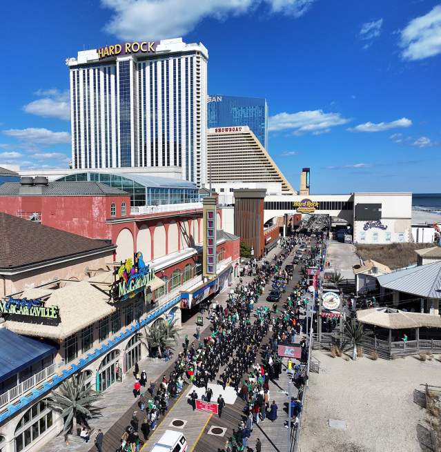 A sunny day in Atlantic City, NJ for the 2025 Atlantic City St. Patrick's Day Parade 2025 as the parade participants wind down the Atlantic City Boardwalk in the North Beach section past Resorts Casino Hotel.