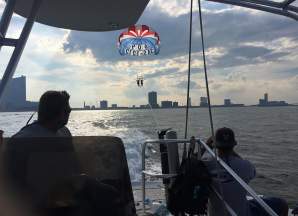 View of the Atlantic City skyline as seen from AC Parasail's boat with a tandem parasail out over the water in Atlantic City.