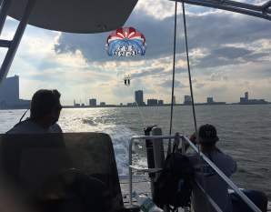 View of the Atlantic City skyline as seen from AC Parasail's boat with a tandem parasail out over the water in Atlantic City.