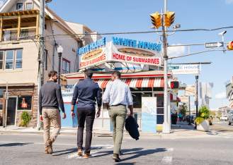 Group of friends walking towards the White House Sub Shop in Atlantic City's Ducktown neighborhood.