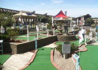 View of Atlantic City Mini Golf course on the Atlantic City Boardwalk with Kennedy Plaza rotunda in background.