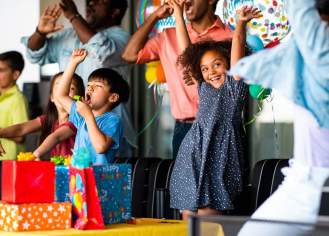 Kids cheer at a birthday party at Top Golf.