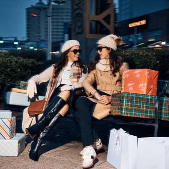 Two women take a break from holiday shopping at Tanger Outlets Atlantic City.