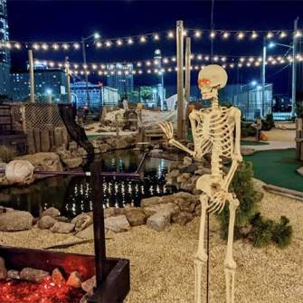 A skeleton and roasting pit props adorn North Beach Mini Golf course for Halloween inspired fun.