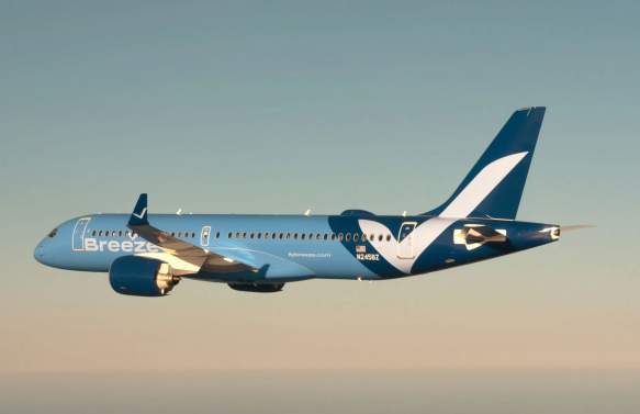 A light blue Breeze Airways jet with a white and dark blue tail design flies against a gradient sky.