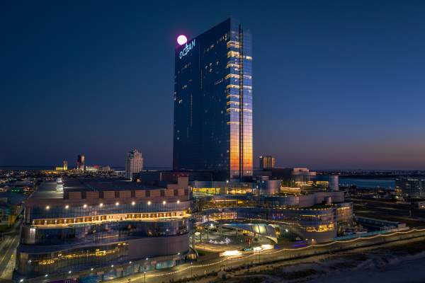 Ocean Casino Resort and Boardwalk with sunrise reflected off of tower.