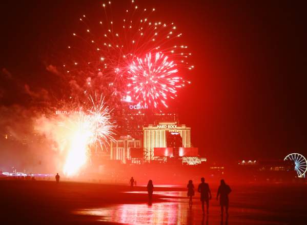 Fireworks light up the beach and Boardwalk with people watching the show at Tropicana in Atlantic City, NJ.