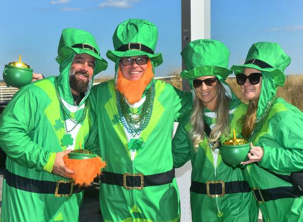 People dressed in leprechaun costumes holding pots of gold on the Atlantic City Boardwalk for the St. Patrick's Day Parade Saturday, March 8, 2025.