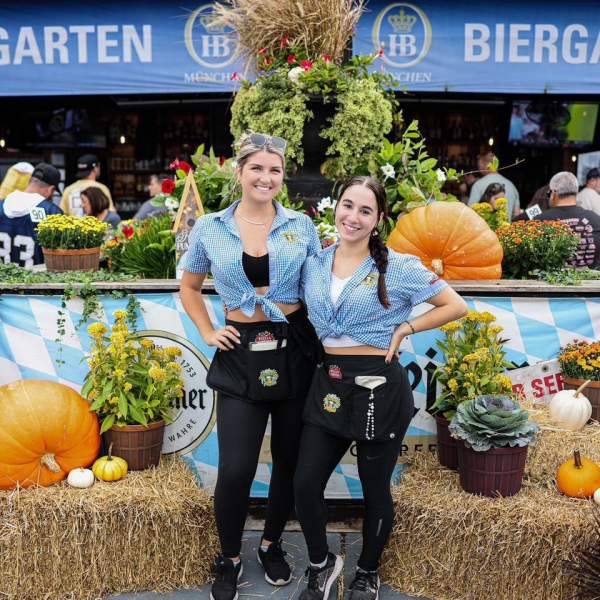 Wait staff at Biergarten pose in front of fall decor in Atlantic City.