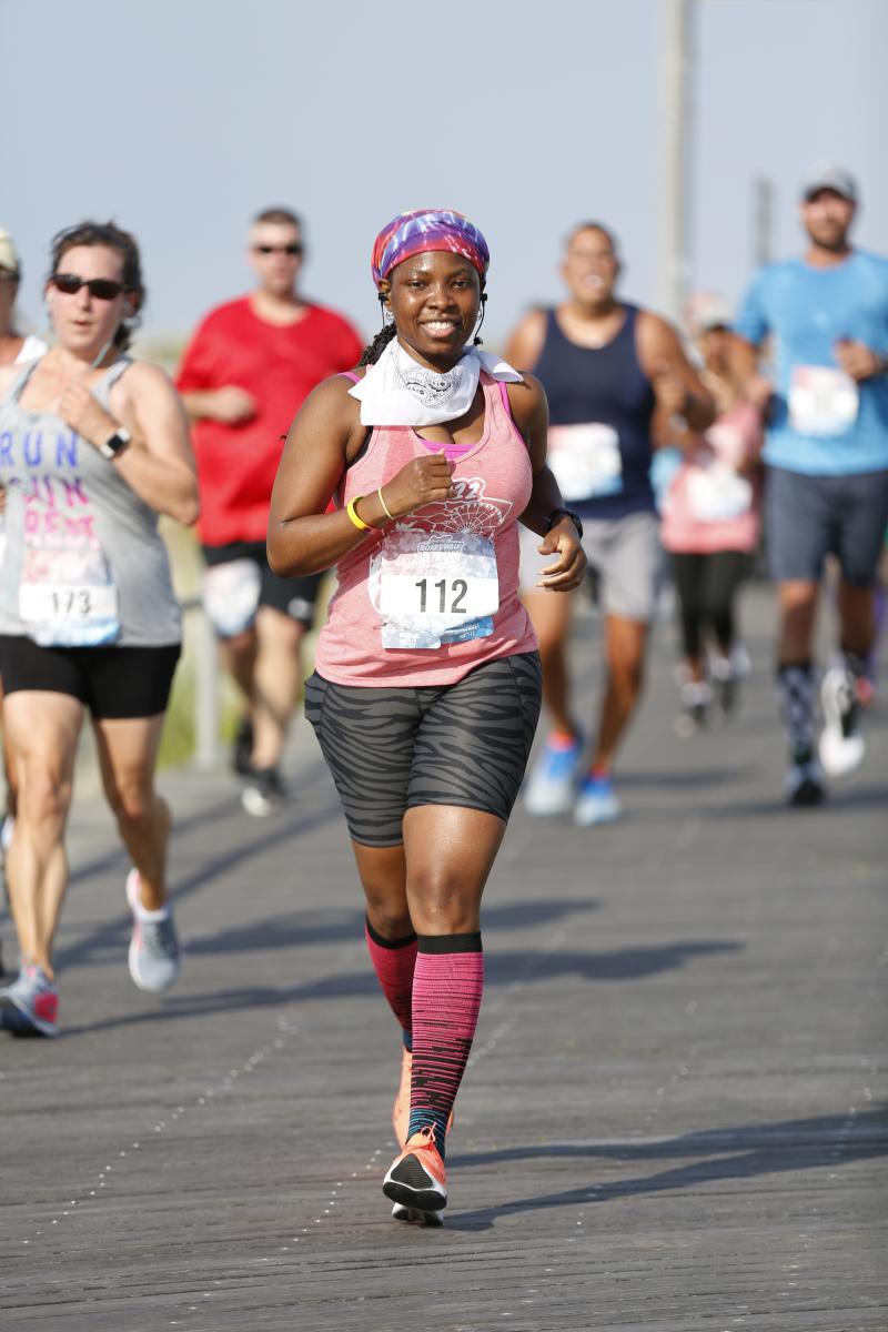 A Woman Running At The Bungalow Beach Run 5k
