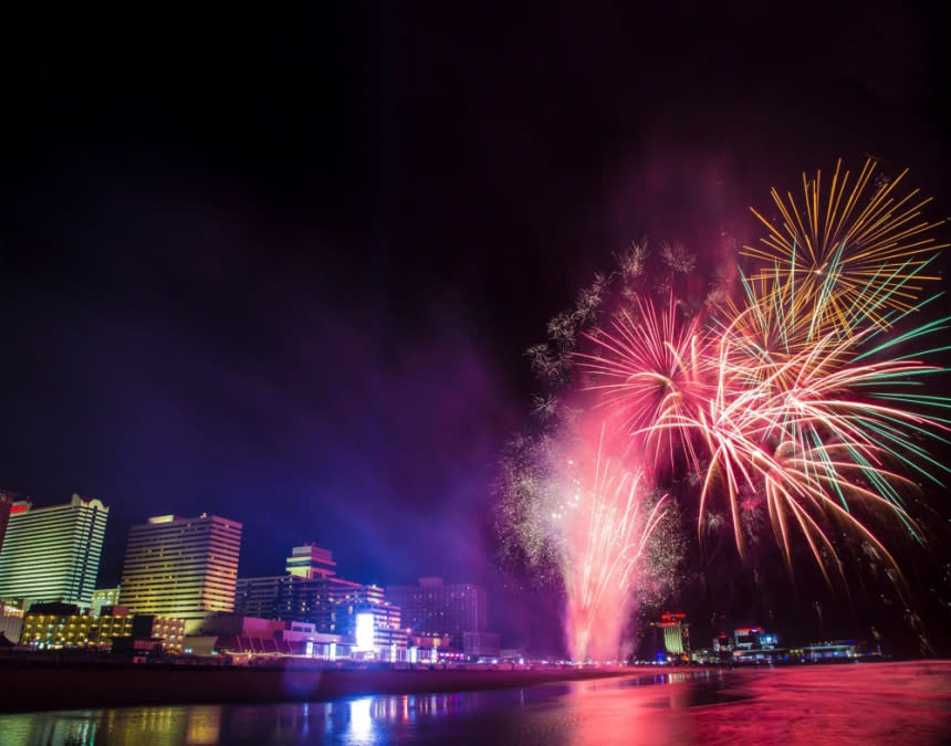 Fireworks light up the beach, Boardwalk and shoreline in Atlantic City during a Tropicana Atlantic City Summer Fireworks show. Tropicana Casino Resort is seen in background as well as other Boardwalk resorts further in the distance.