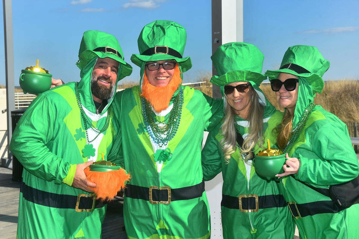 People dressed in leprechaun costumes holding pots of gold on the Atlantic City Boardwalk for the St. Patrick's Day Parade Saturday, March 8, 2025.