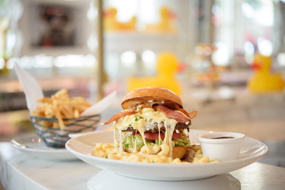 Melty Mac and Cheese Burger with Bacon and crispy french fries plated at Sugar Factory at Hard Rock Hotel & Casino in Atlantic City.