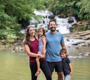 family in front of a waterfall